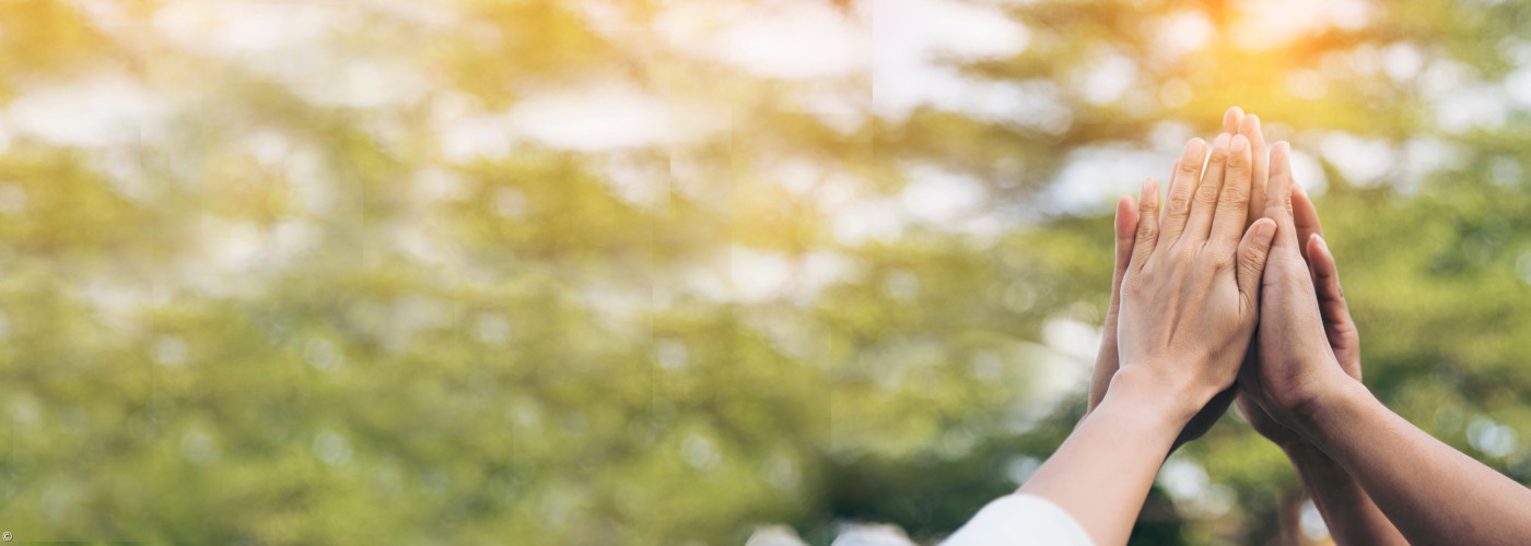 Menschen, die ihre Hände in den Himmel halten und zusammenlegen